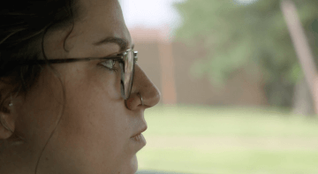 A still from the movie LOUD ENOUGH, with Madison Smith staring out of a car