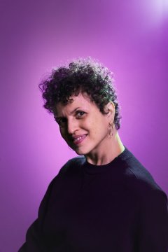 Headshot of Michele Stephenson against a purple backdrop