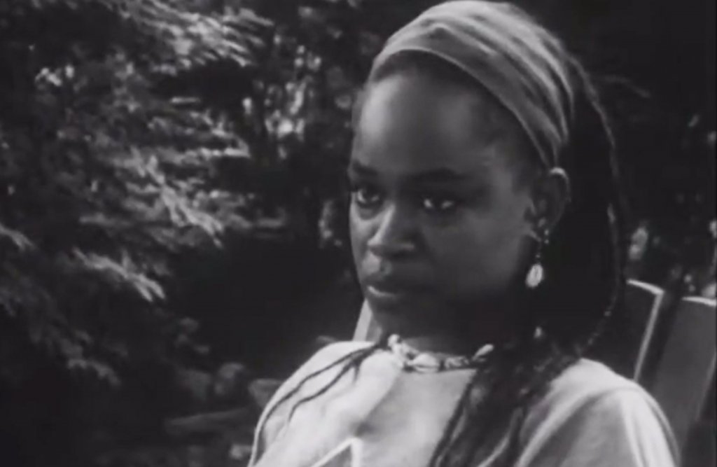 A black and white photo of a Black woman looking off to the side